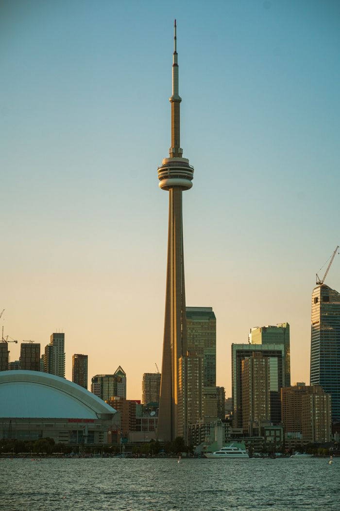 Capture of Toronto skyline featuring the CN Tower and cityscape during sunset.